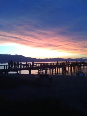 a group of people walking on a pier at sunset at Black Jack Inn in South Lake Tahoe