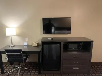 a room with a desk with a television on a wall at Black Jack Inn in South Lake Tahoe