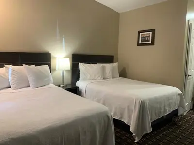 a hotel room with two beds with white sheets at Black Jack Inn in South Lake Tahoe