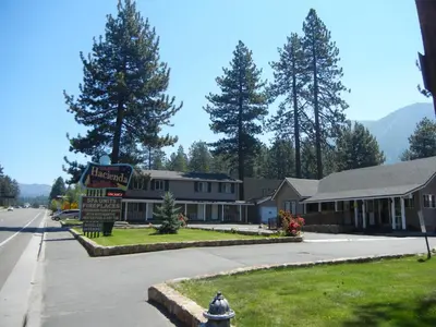a building with a sign in the middle of a street at Tahoe Hacienda Inn in South Lake Tahoe