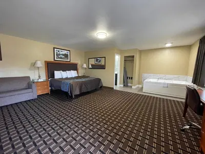 a hotel room with a bed and a couch at Tahoe Hacienda Inn in South Lake Tahoe