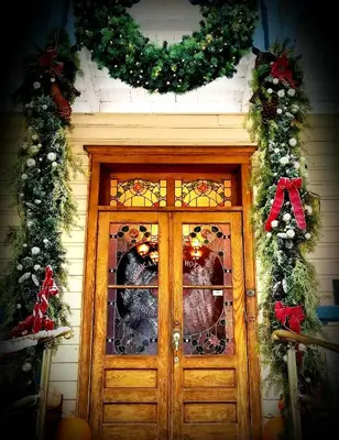 a door with christmas wreaths on a house at American River Inn in Georgetown
