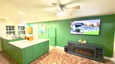 a kitchen with a fireplace and a tv on the wall at Westhaven Inn Pollock Pines Camino in Pollock Pines