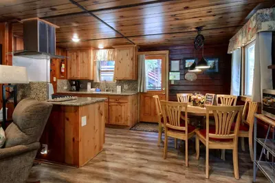a kitchen and dining room with a table and chairs at 16 Chipmunks Holiday in Wawona