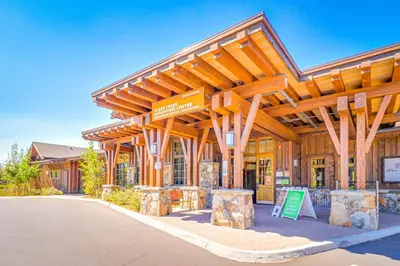 a large wooden building with a sign in front of it at Wooded Escape in Donner Pines Tract