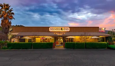 a building with a sign that reads minnesota inn at Miners Inn in Mariposa