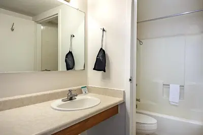 a bathroom with a sink and a toilet and a mirror at Miners Inn in Mariposa