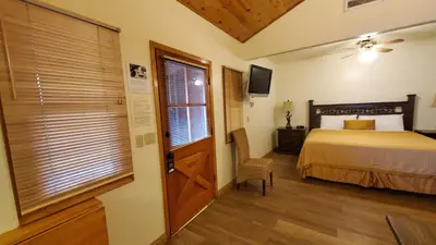 a bedroom with a bed and a window and a door at Kernville Inn in Kernville
