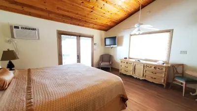 a bedroom with a bed and a dresser and a window at Kernville Inn in Kernville