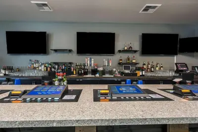a bar with a counter with alcohol bottles on it at Studio 6-Mccarran, NV - Sparks - Tahoe - Reno Industrial Center in Clark