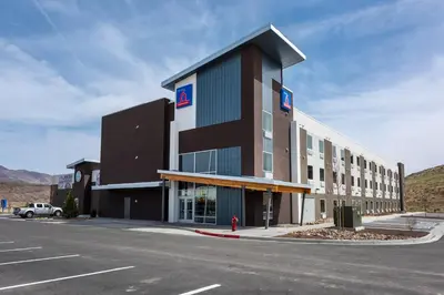 a large building with a parking lot in front of it at Studio 6-Mccarran, NV - Sparks - Tahoe - Reno Industrial Center in Clark