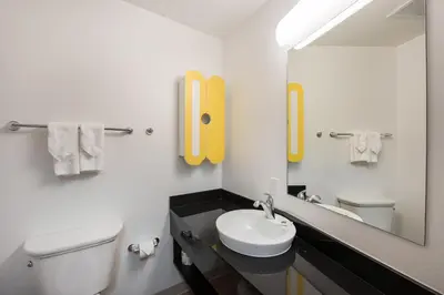 a bathroom with a toilet and a sink and a mirror at Studio 6-Mccarran, NV - Sparks - Tahoe - Reno Industrial Center in Clark