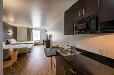 a small hotel room with a kitchen and a bedroom at Studio 6-Mccarran, NV - Sparks - Tahoe - Reno Industrial Center in Clark