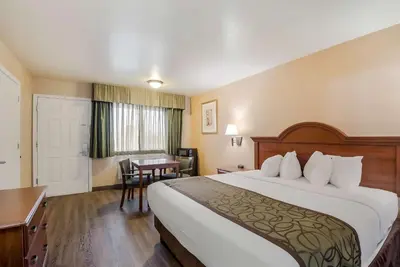 a hotel room with a large bed and a desk at SureStay Hotel by Best Western Fernley in Fernley
