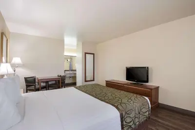 a hotel room with a bed and a flat screen tv at SureStay Hotel by Best Western Fernley in Fernley