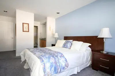 a bedroom with a large bed with a wooden headboard at Mountainback 62 in Mammoth Lakes