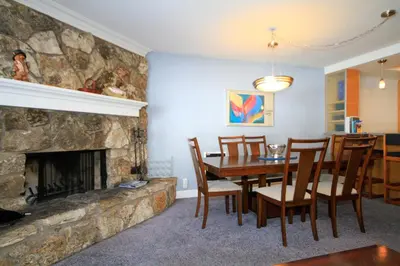 a dining room with a table and a fireplace at Mountainback 62 in Mammoth Lakes