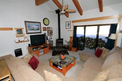 a living room with a couch and a tv at Courchevel 51 in Mammoth Lakes