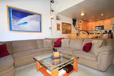 a living room with a couch and a table at Courchevel 51 in Mammoth Lakes