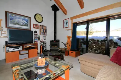 a living room with a couch and a tv at Courchevel 51 in Mammoth Lakes