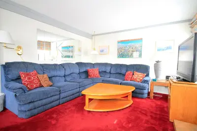 a living room with a blue couch and a table at Mammoth Ski Racquet Club 74 1 Bdrm Loft in Mammoth Lakes