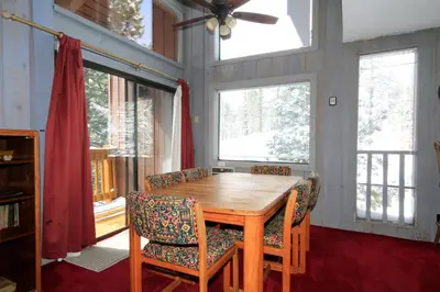 a dining room with a wooden table and chairs at Mammoth Ski Racquet Club 74 1 Bdrm Loft in Mammoth Lakes