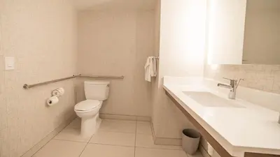 a bathroom with a toilet and a sink at Holiday Inn Express Porterville by IHG in Porterville