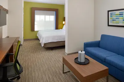 a hotel room with a couch and a bed at Holiday Inn Express Lodi by IHG in Lodi