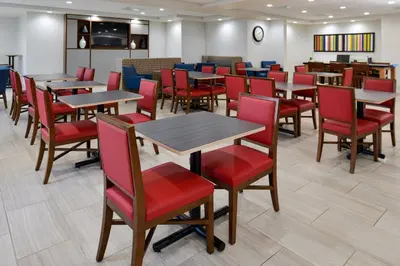 a dining room with tables and red chairs at Holiday Inn Express Lodi by IHG in Lodi
