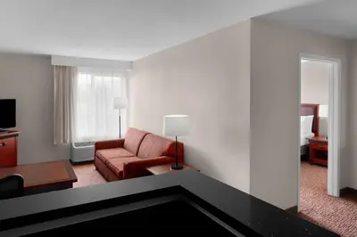 a living room with a couch and a chair in a hotel room at Larkspur Landing Extended Stay Suites Folsom in Folsom