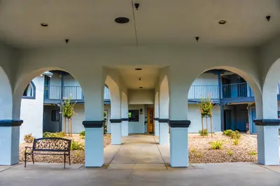an empty building with a bench in a courtyard at Oak Ridge Inn in Plymouth