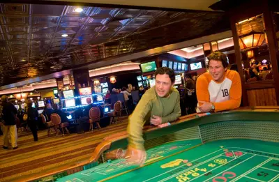 two men playing poker at a table in a casino at Carson Valley Motor Lodge and Suites in Minden
