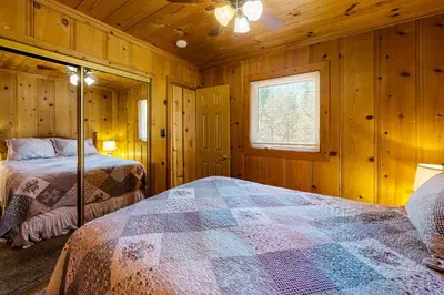 a bedroom with two beds in a wooden cabin at Cozy Seclusion in South Lake Tahoe