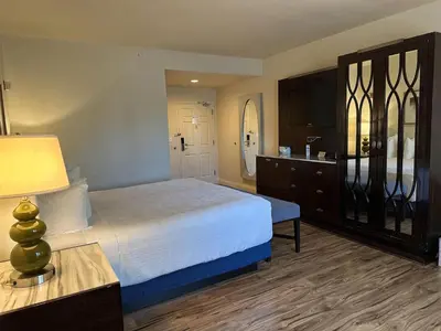 a bedroom with a bed and a dresser at Rocklin Park Hotel, Trademark Collection by Wyndham in Rocklin