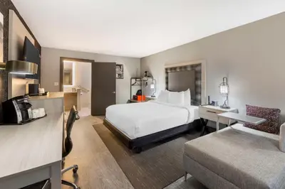 a hotel room with a bed and a couch at Aiden by Best Western South Reno in Reno