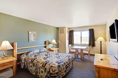 a hotel room with a bed and a desk at Topaz Lodge in Gardnerville