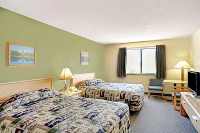 a hotel room with two beds and a television at Topaz Lodge in Gardnerville