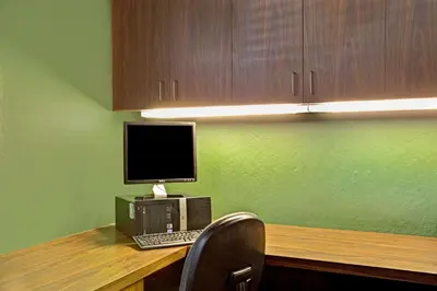 a desk with a computer and a laptop on it at Topaz Lodge in Gardnerville