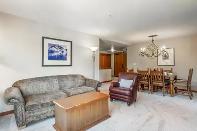 a living room with a couch and a dining room at Village 1401 in Mammoth Lakes