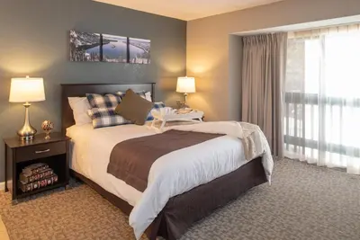 a bedroom with a large bed and a window at Thunderbird Resort Club in Reno
