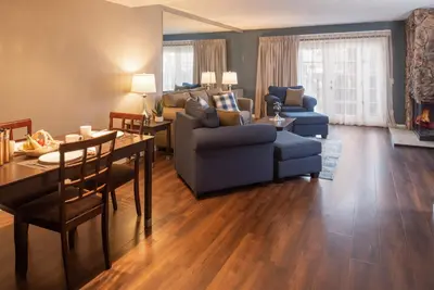 a living room with a couch and a table and chairs at Thunderbird Resort Club in Reno