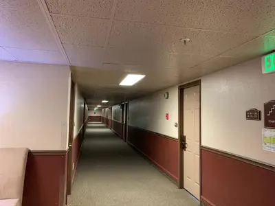 an empty hallway in a hospital with a long corridor at Hardman House in Carson City
