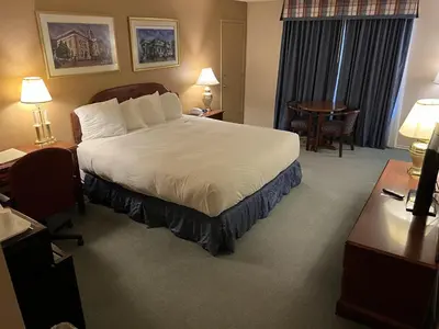 a hotel room with a bed and a desk at Hardman House in Carson City