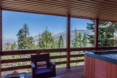 a room with a tub and a chair and a view at Bridges Townhome #11 Townhouse in Mammoth Lakes