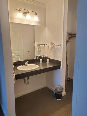a bathroom with a sink and a mirror at Sequoia Inn in Hanford