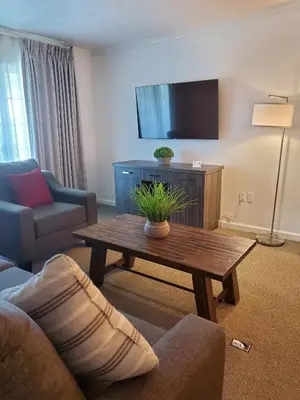 a living room with a couch and a coffee table at Sequoia Inn in Hanford