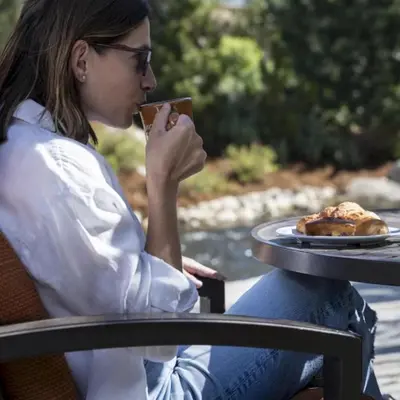 a woman sitting at a table with a plate of food at Wayfinder Bishop in Bishop
