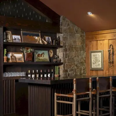 a bar with some bottles of wine and some chairs at Wayfinder Bishop in Bishop