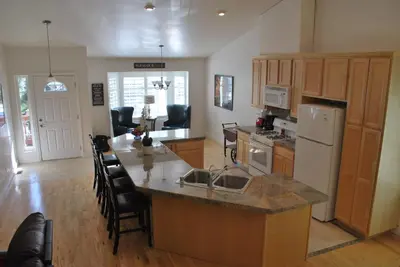 a kitchen with a large island with a counter top at Big Tom's Cabin by Yosemite, lake and trails in Groveland