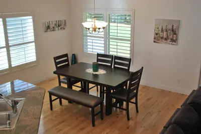 a dining room with a black table and chairs at Big Tom's Cabin by Yosemite, lake and trails in Groveland